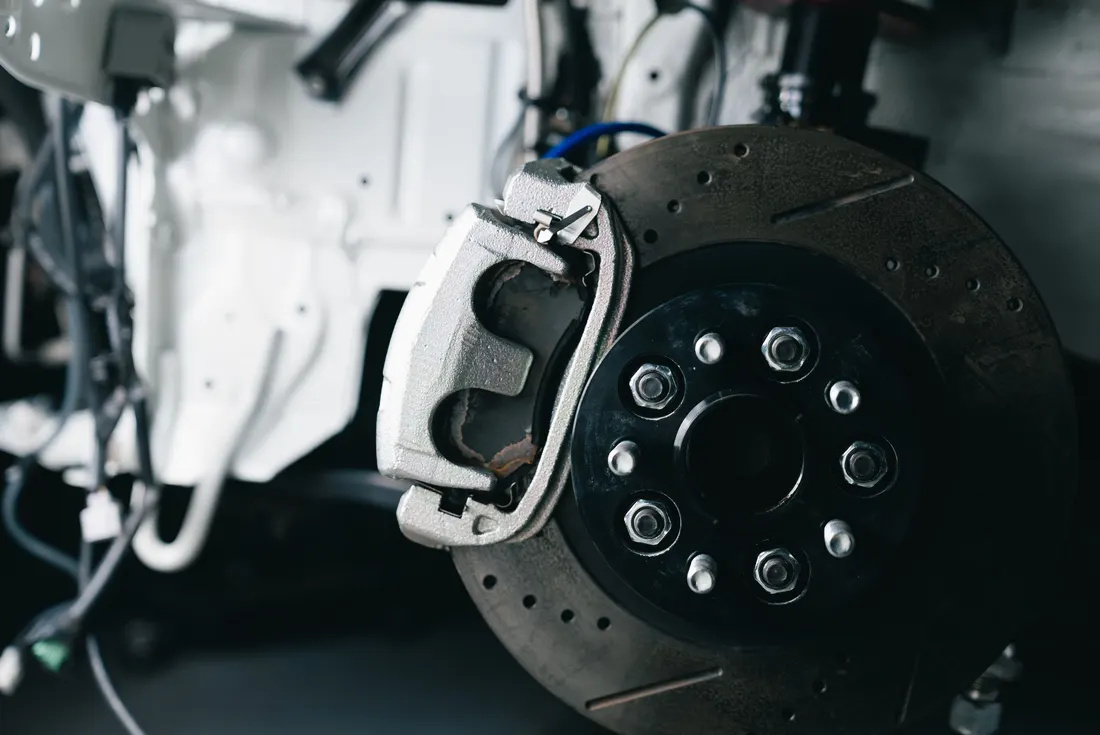 Brake repair — close-up of a car brake caliper and disc rotor